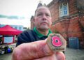David Dunham, poppy appeal coordinator for Wokingham, holds an 80th anniversary commemorative badge. Events around the borough will remember the sacrifices made. Picture:Andrew Batt