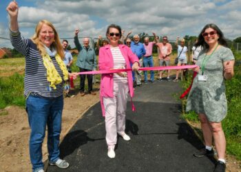 "The Path To Nowhere" finally opened in Hyde End Lane on Saturday morning. Helen Bouchami (centre) cuts the tape, held by Cllr. Catherine Glover and Parish Cllr. Nadine Masseron.