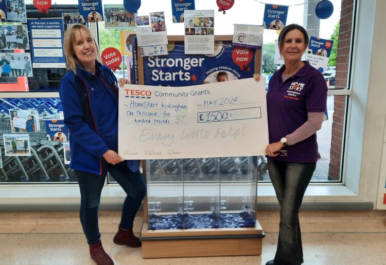 Louise Jedras, the Tesco community champion (left), presents a cheque to the charity.