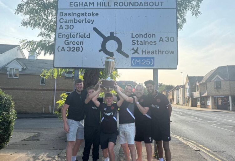Wokingham Town players with the trophy in Egham
