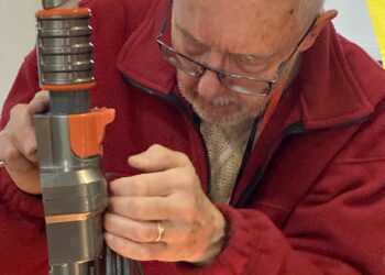 The team of fixers at Wokingham Repair Cafe have reached the UK's top 10, repairing 108 items in just two sessions. One of the team is here hard at work. Picture: Emma Merchant
