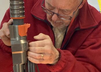 The team of fixers at Wokingham Repair Cafe have reached the UK's top 10, repairing 108 items in just two sessions. One of the team is here hard at work. Picture: Emma Merchant