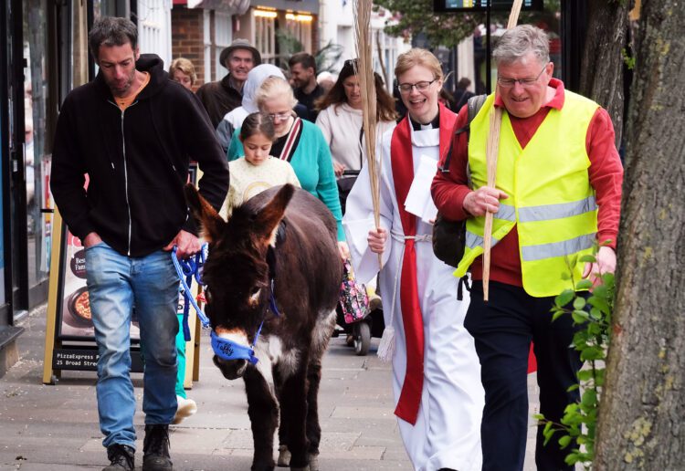 Taffy the donkey and Revd Hannah Higginson led a procession of All Saints parishioners to visit Wokingham church neighbours on Palm Sunday. Picture: Andrew Batt