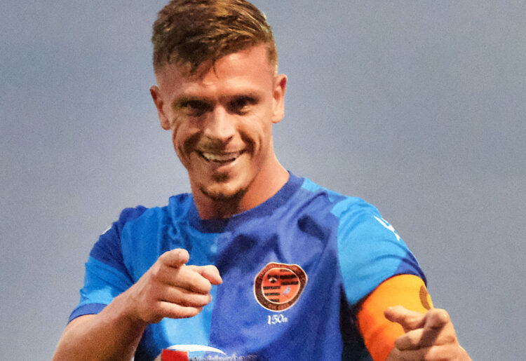 Sean Moore celebrates his two goals for Wokingham Town on his league debut for the club. Pic: Andrew Batt.