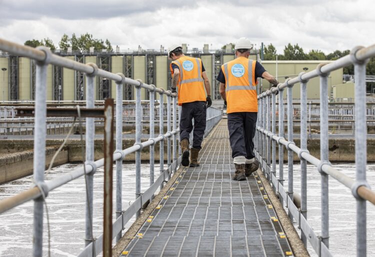 Two technicians inspect aeration lanes at a sewage works. Credit: Thames Water