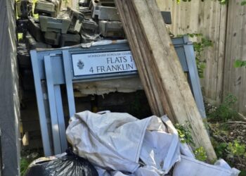 Road signs with the Wokingham Borough Council logo dumped behind Ashridge Farm in Bell Foundry Lane. Credit: Peter Humphreys