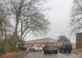 A photo of drivers queuing to get into Hurst Lodge School in Crowthorne, with Broadmoor Hospital in the background. Credit: Councillor Tina Eberle