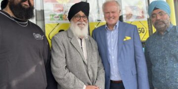 Clive Jones with the owners of Londis on Barkham Road. Picture: Elisabeth Montague