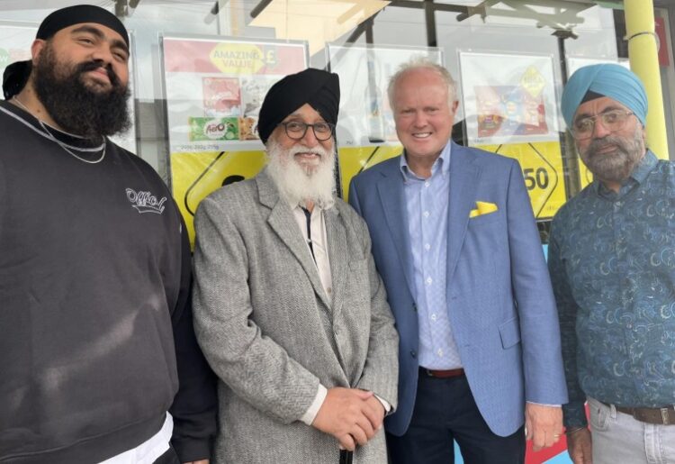 Clive Jones with the owners of Londis on Barkham Road. Picture: Elisabeth Montague