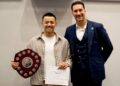 Danny Wang received the trophy for his Humerous Speech, presented by Toastmaster area director Mohammed Al Bayati. Picture: courtesy of Danny Wang
