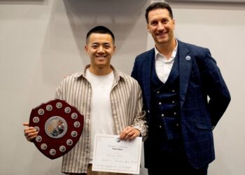 Danny Wang received the trophy for his Humerous Speech, presented by Toastmaster area director Mohammed Al Bayati. Picture: courtesy of Danny Wang