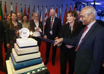 Florence Rabier (Director-General of ECMWF, second from right) and Rohit Tanna (Deputy Lieutenant of Berkshire, right) cut the 50th anniversary cake during the anniversary reception at ECMWF headquarters in Reading. Picture: Philip Hollis