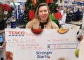Hannah Norris from Me2Club received a cheque from Tesco Wokingham's Community Bookshelf donations. Picture: Tesco Wokingham