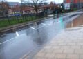 Flooding beside Wokingham's Carnival Pool has forced some pedestrians to jump out of the way to avoid being splashed by passing cars