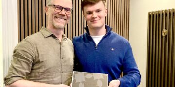 Roger and lucky prize draw winner Sam Methold celebrate Roger Duckworth Physiotherapy's 30th anniversary. Picture: Emma Merchant