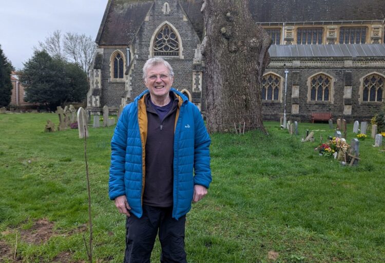 Andy Clark with the new St Paul's Church rowan and the stump of the Cedar of Lebanon. Picture: St Paul's Church