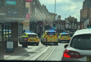 Multiple police vehicles remain on the scene on Peach Street as investigations into the assault continue, with ongoing disruption to traffic expected.