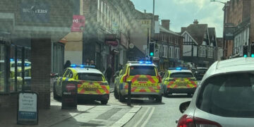 Multiple police vehicles remain on the scene on Peach Street as investigations into the assault continue, with ongoing disruption to traffic expected.