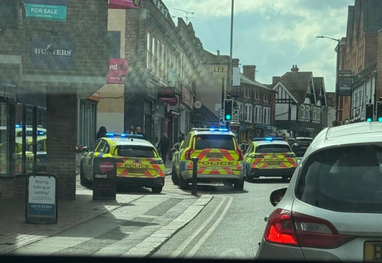 Multiple police vehicles remain on the scene on Peach Street as investigations into the assault continue, with ongoing disruption to traffic expected.