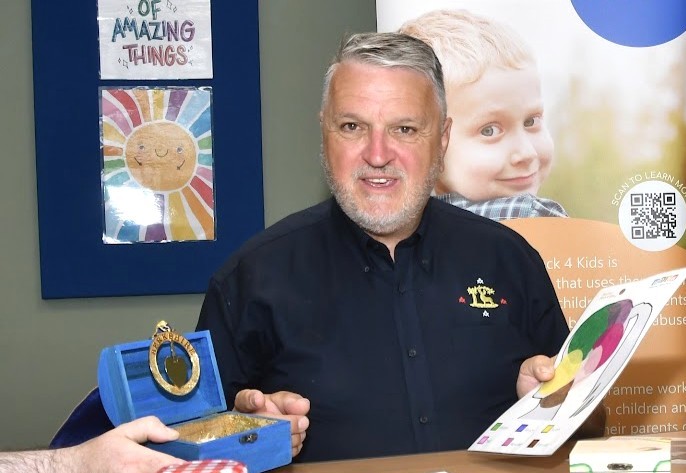 Peter Hopkins from Berkshire Freemasons being shown some of the work and therapeutic aids used in sessions by Martin, a BB4K Support Worker. Picture BF