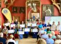Wokingham Lions had much to celebrate at their Town Hall event. May Fayre stallholders receive donations. Picture: Emma Merchant