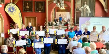 Wokingham Lions had much to celebrate at their Town Hall event. May Fayre stallholders receive donations. Picture: Emma Merchant