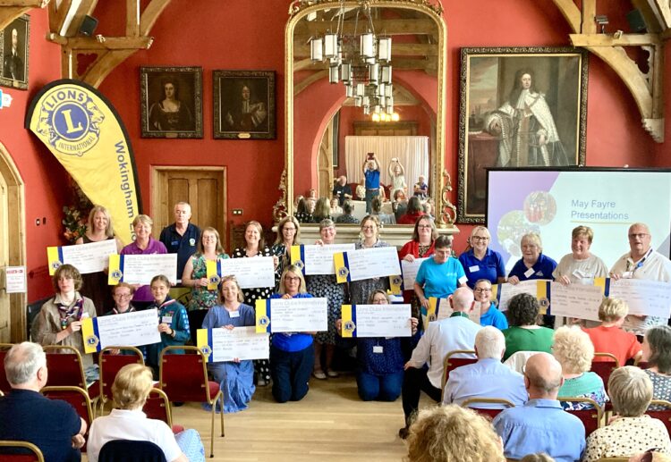 Wokingham Lions had much to celebrate at their Town Hall event. May Fayre stallholders receive donations. Picture: Emma Merchant