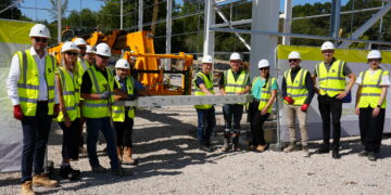 steel signing ceremony on site as part of the completion of the first structural steel frame.