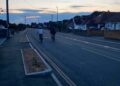 Two cyclists choose to use the main road rather than the dedicated cycle lane created in Woodlands Avenue for the Woodley Active Travel Route. Credit: UGC