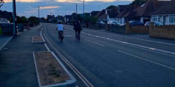 Two cyclists choose to use the main road rather than the dedicated cycle lane created in Woodlands Avenue for the Woodley Active Travel Route. Credit: UGC