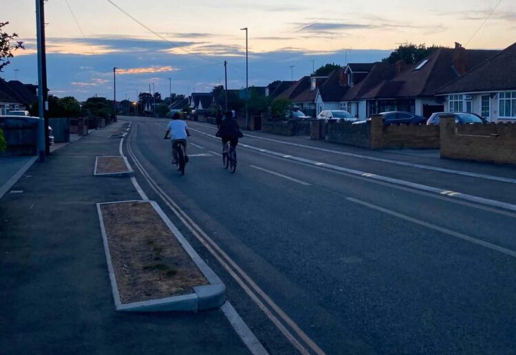 Two cyclists choose to use the main road rather than the dedicated cycle lane created in Woodlands Avenue for the Woodley Active Travel Route. Credit: UGC