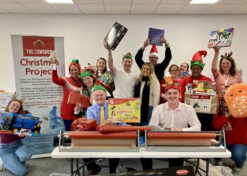 Wokingham MP Clive Jones helped wrap children's Christmas presents at The Cowshed. Picture: Emma Merchant
