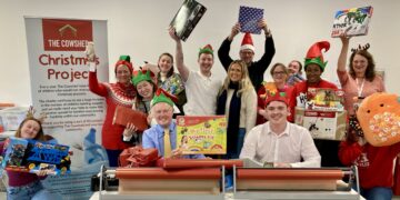 Wokingham MP Clive Jones helped wrap children's Christmas presents at The Cowshed. Picture: Emma Merchant